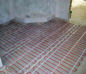 Radiant floor heating cable being installed.