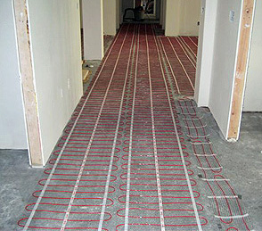 Electric radiant heat cable being installed for heated floor.